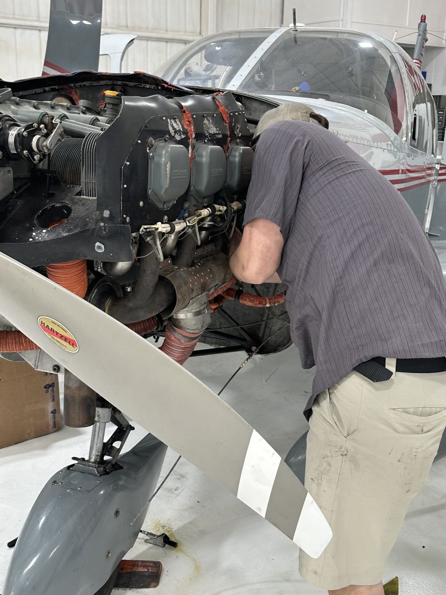 Mach technician servicing a Lycoming engine on a general aviation aircraft