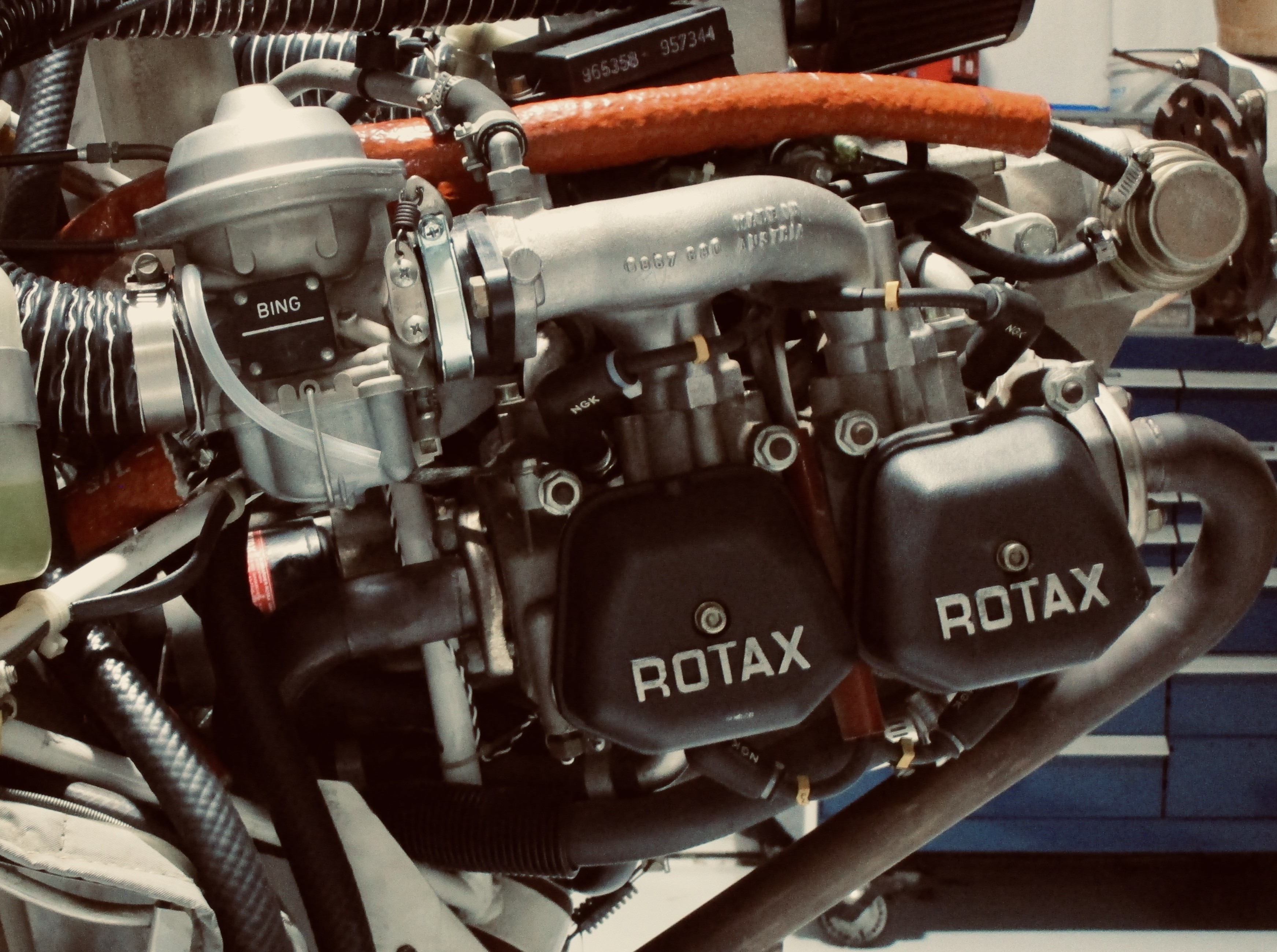 Close-up of a Rotax aircraft engine and carburetor installation